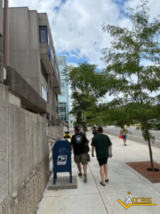 Supporters walk alongside Carl Schulze as the group approaches the State Capitol, united in calling for the protection of Medicaid-funded home and community-based care.